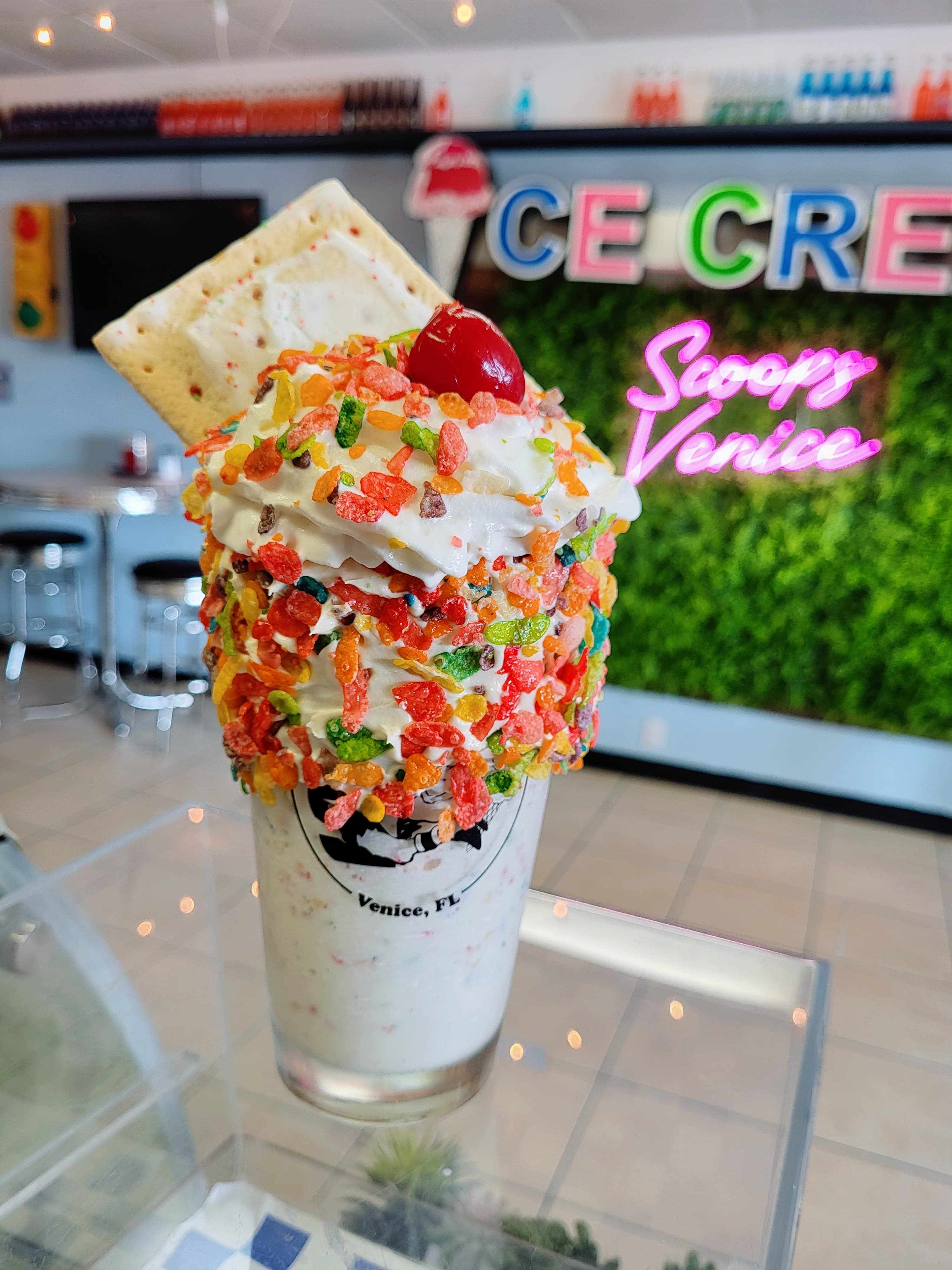 A shake under the shop's neon sign at Scoops Venice Ice Cream